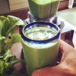 Glass filled with green spinach smoothie.