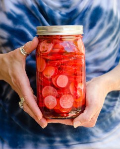Georgia holding jar of pickled radishes