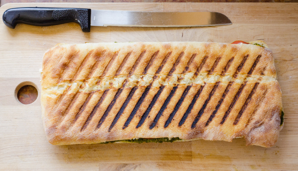 vegan pesto panini on cutting board, ready to serve