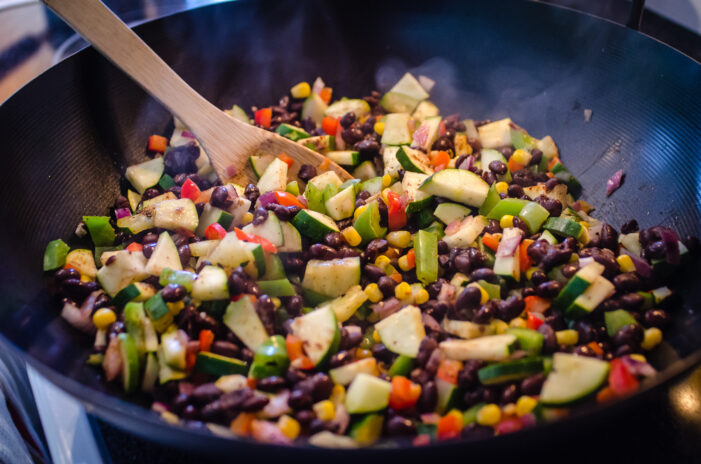 Cooking up the veggie enchilada filling in the wok