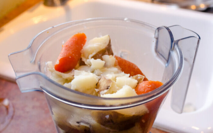 Potatoes and carrots ready to become nacho cheese sauce in the Vitamix