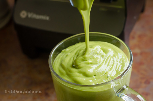 Pouring out a large serving of this delicious superfood green smoothie!