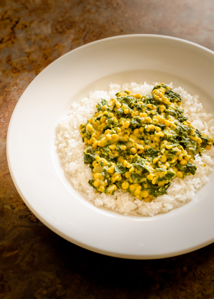 vegan indian dal on rice in a white plate