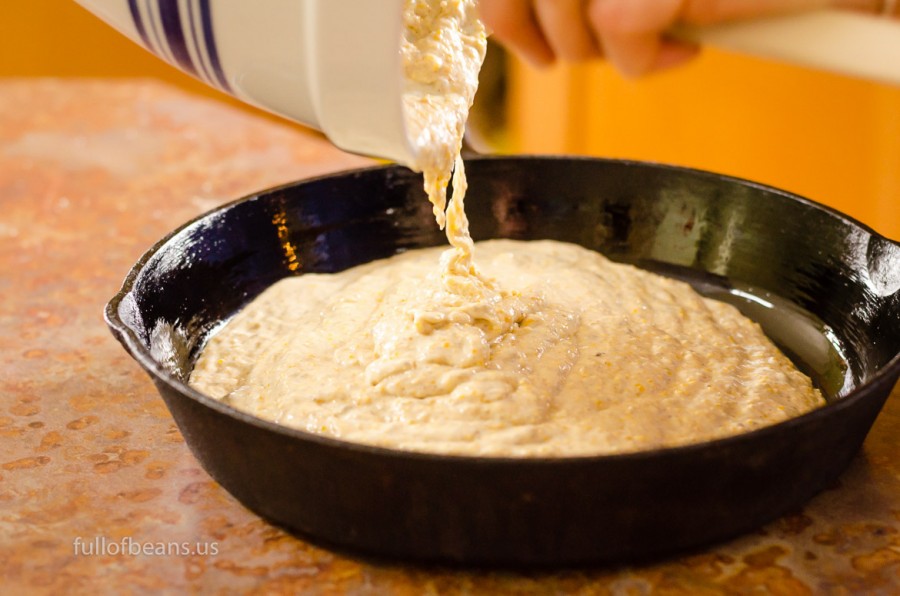 Pouring the vegan cornbread batter into our favorite cast iron pan. Quick! Get it to the oven!