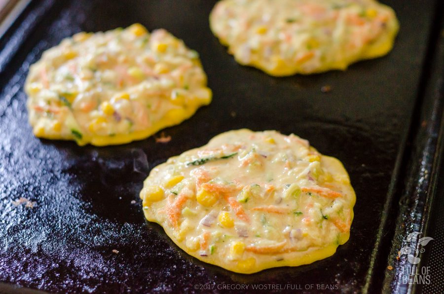 fritters cooking on griddle