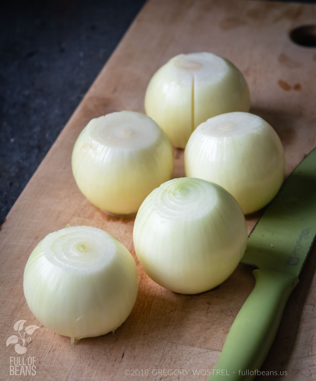 white onions on a cutting board