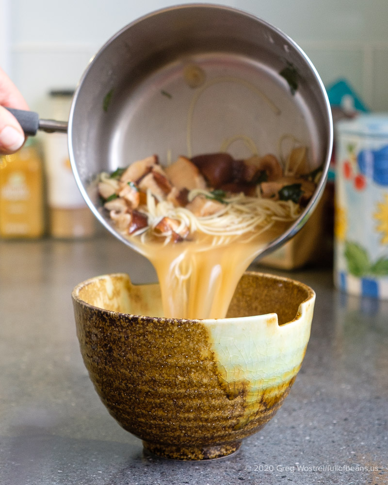 pouring a serving of vegan miso noodle soup