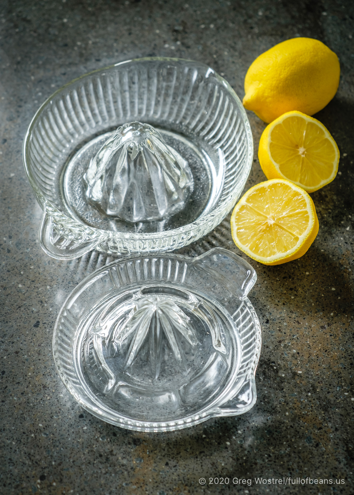 glass citrus juicers with lemons
