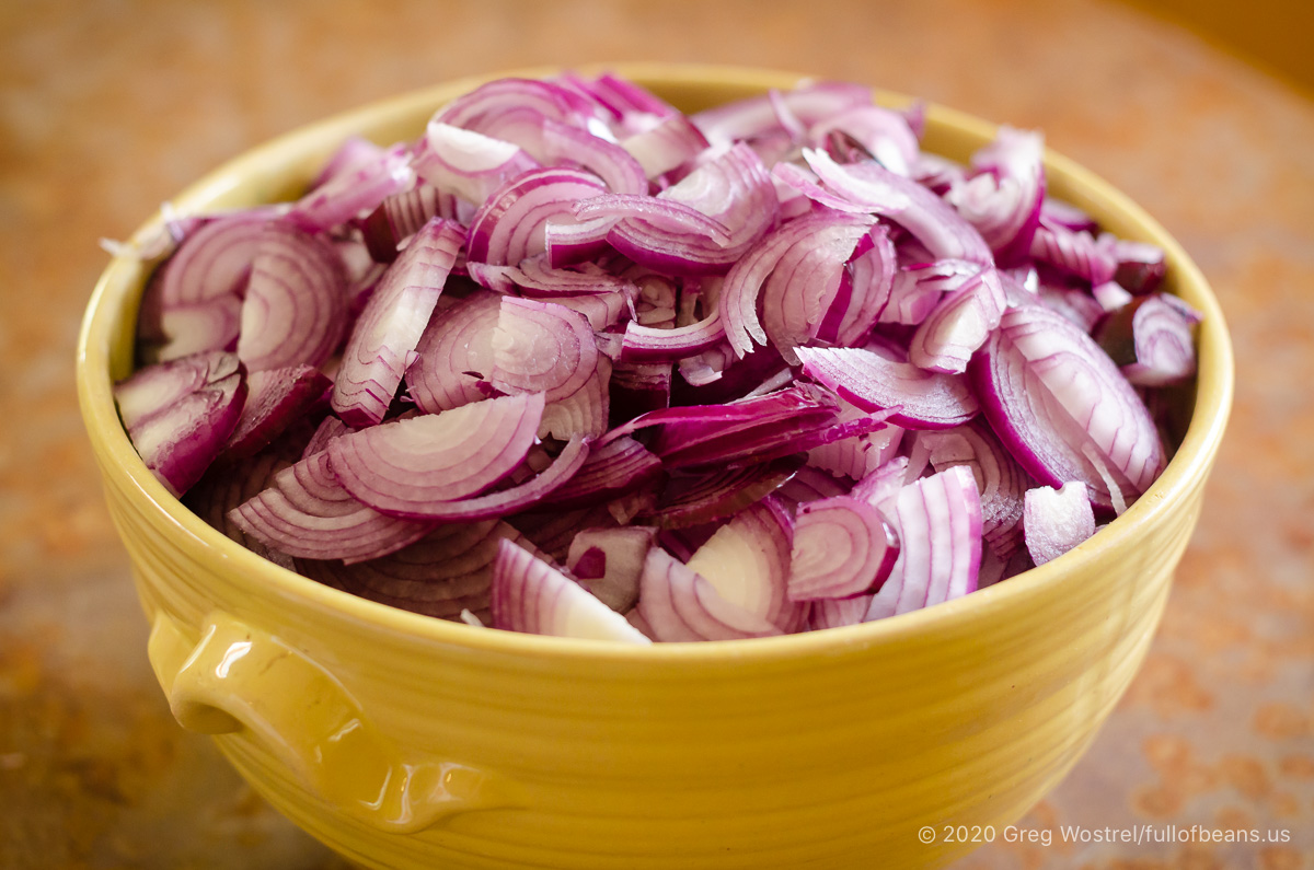 raw red onions sliced and ready to be made into jam
