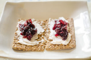 vegan red onion jam on crackers and cheese
