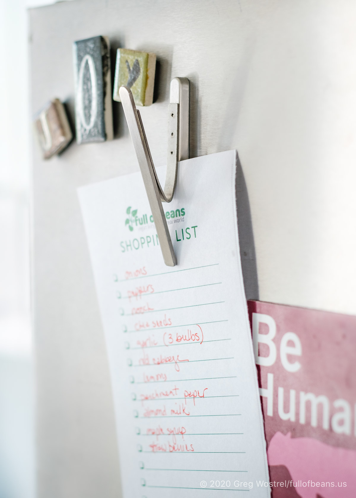IKEA Magnetic clip holding a shopping list on a fridge door