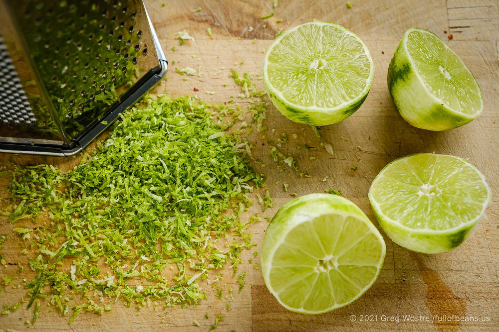 Fresh limes, lime zest, and a grater