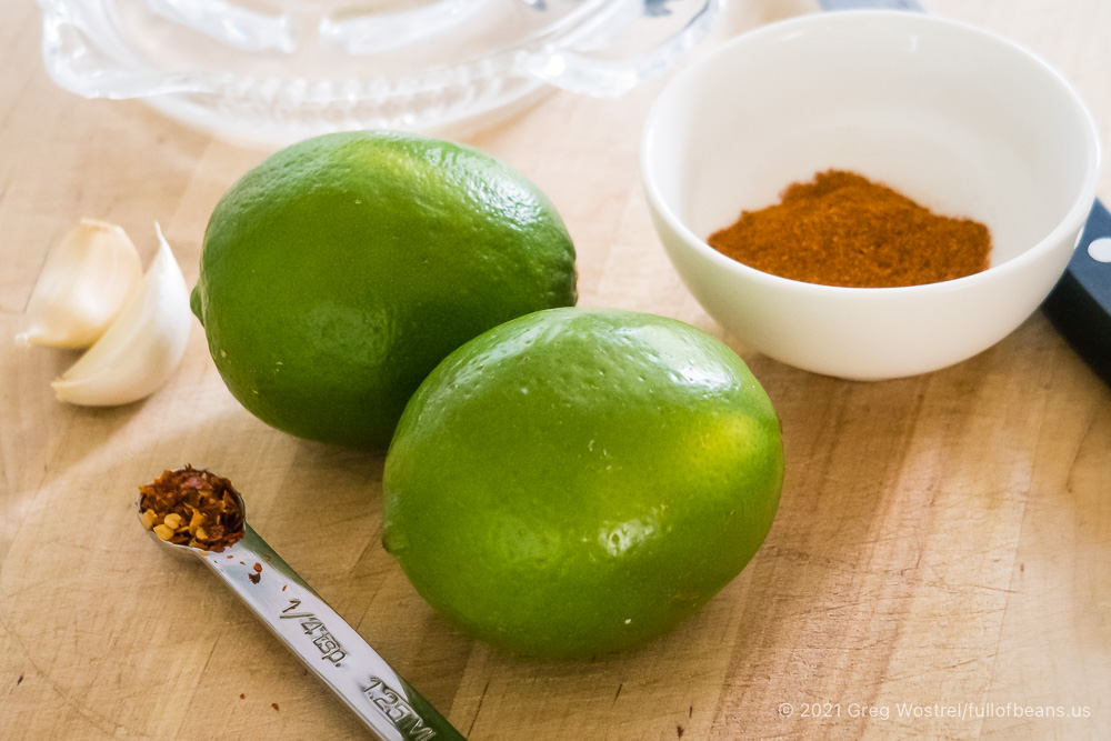 2 limes, chili powder, garlic cloves, and red pepper flakes for Zesty Lime Marinade