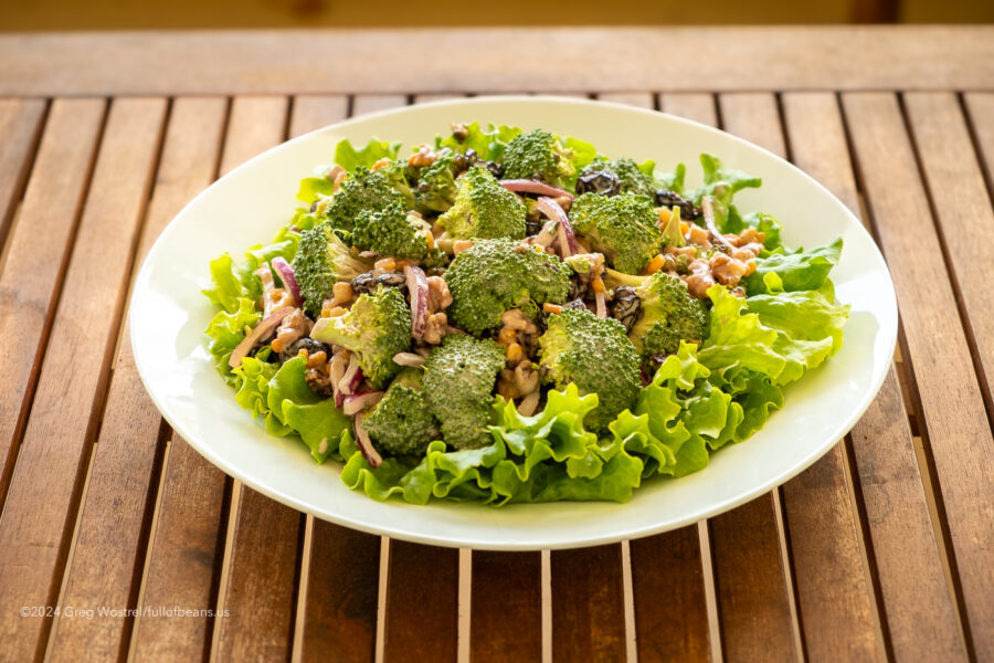 Vegan broccoli and bacon salad on a white plate